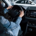 different-buttons-knobs-cute-girl-with-black-hair-trying-her-brand-new-expensive-car-automobile-salon_146671-16082