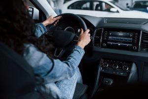 different-buttons-knobs-cute-girl-with-black-hair-trying-her-brand-new-expensive-car-automobile-salon_146671-16082