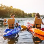 couple-together-kayaking-river_1303-16040