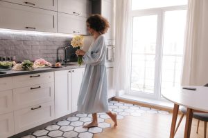 full-view-happy-woman-with-flowers-home_197531-33087