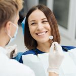 male-professional-dentist-with-gloves-mask-discuss-what-treatment-will-look-like-patient-s-teeth_158595-7630