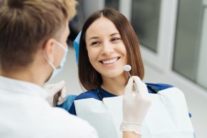 male-professional-dentist-with-gloves-mask-discuss-what-treatment-will-look-like-patient-s-teeth_158595-7630